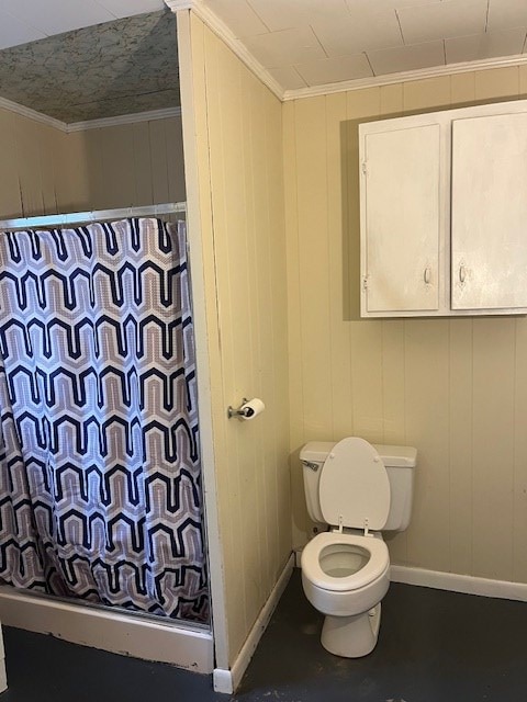 bathroom featuring ornamental molding and toilet