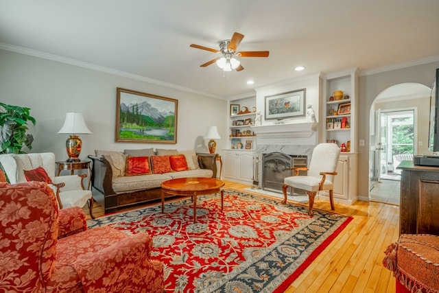 1694 Burnt Oak Dr Unit 208, Dalton, GA 30721 - living room with arched walkways, a ceiling fan, ornamental molding, a fireplace, and wood-type flooring