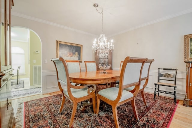 1694 Burnt Oak Dr Unit 208, Dalton, GA 30721 - dining room featuring light wood-style floors, arched walkways, crown molding, a wainscoted wall, and a chandelier