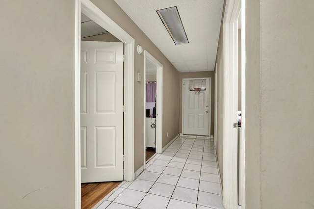 corridor featuring light tile patterned floors