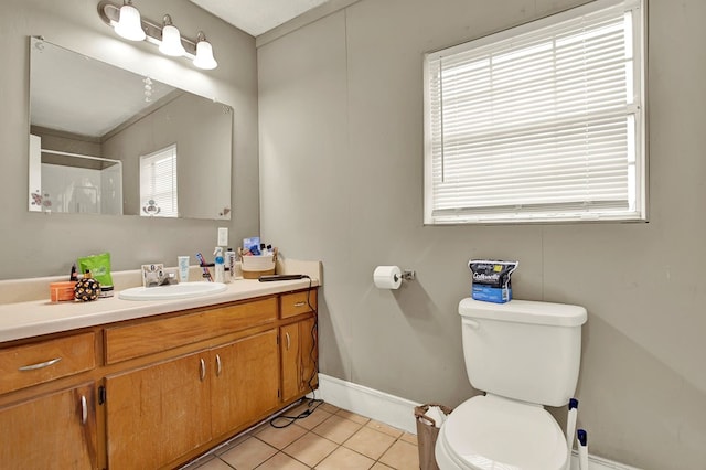 bathroom featuring tile patterned flooring, vanity, and toilet