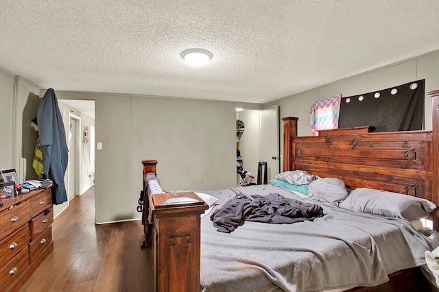 bedroom with dark wood-type flooring and a textured ceiling