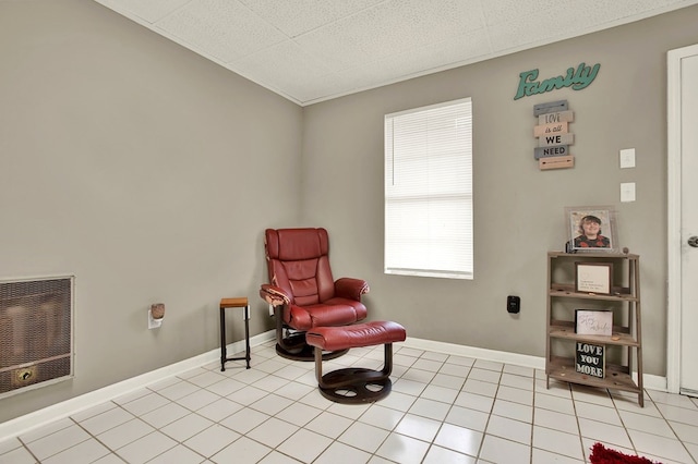 living area with heating unit and light tile patterned floors