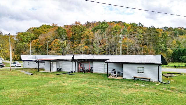 rear view of property featuring a lawn