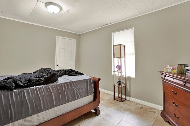 bedroom featuring light tile patterned flooring and crown molding