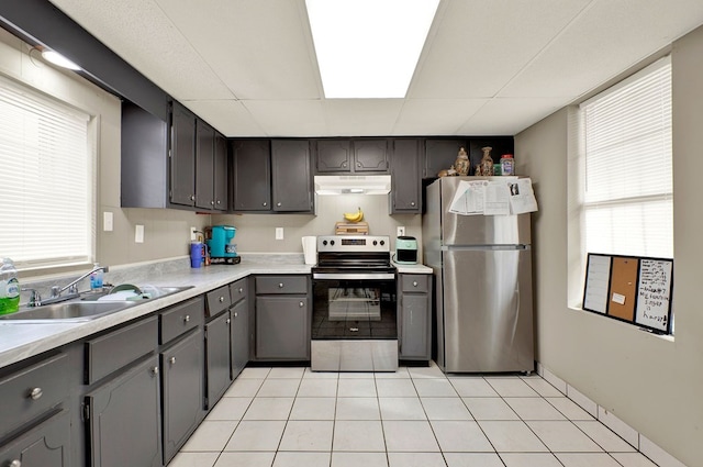 kitchen with light tile patterned flooring, appliances with stainless steel finishes, and sink