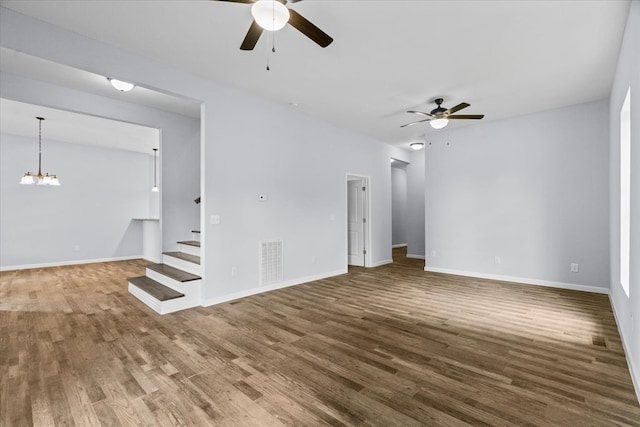 429 Glenwood Ave, Dalton, GA 30721 - unfurnished living room featuring a ceiling fan, stairs, wood finished floors, and a chandelier