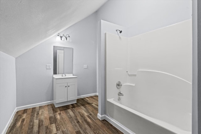 429 Glenwood Ave, Dalton, GA 30721 - bathroom with wood finished floors, bathing tub / shower combination, vanity, lofted ceiling, and a textured ceiling