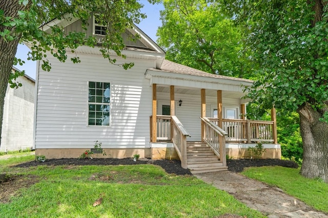429 Glenwood Ave, Dalton, GA 30721 - view of front of home with a porch, board and batten siding, a front lawn, and roof with shingles