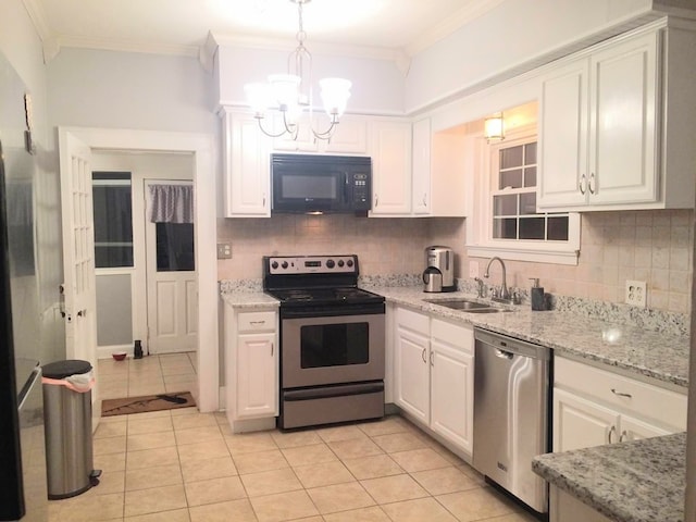 902 Walnut Ave, Dalton, GA 30720 - kitchen with pendant lighting, white cabinetry, sink, ornamental molding, and stainless steel appliances