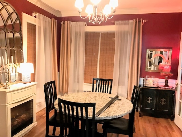 902 Walnut Ave, Dalton, GA 30720 - dining space featuring a fireplace, crown molding, wood-type flooring, and a notable chandelier