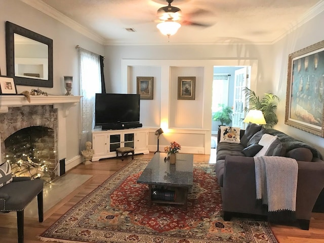 902 Walnut Ave, Dalton, GA 30720 - living room with a tiled fireplace, wood-type flooring, ornamental molding, and ceiling fan