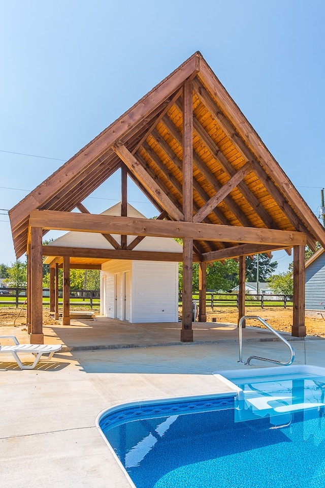outdoor pool with a gazebo and a patio