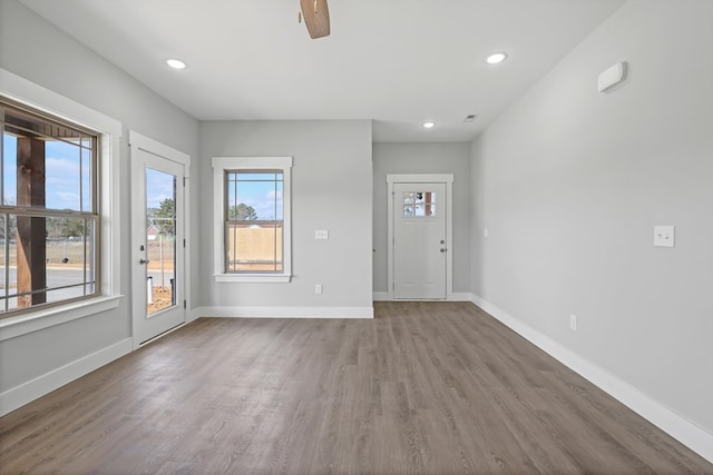 interior space featuring recessed lighting, wood finished floors, and baseboards