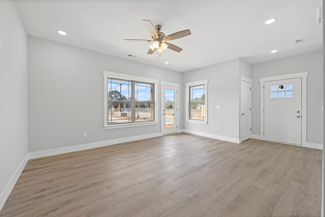 interior space featuring recessed lighting, a ceiling fan, light wood-style floors, visible vents, and baseboards