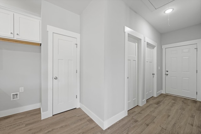 foyer with light wood-style flooring and baseboards