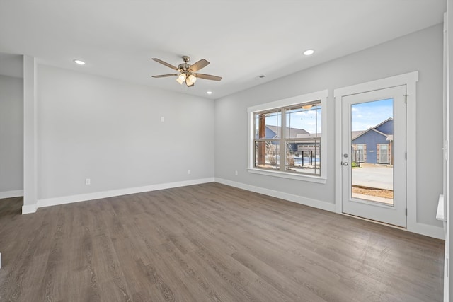 unfurnished living room with ceiling fan, recessed lighting, wood finished floors, and baseboards