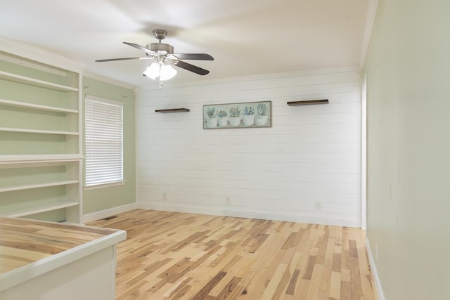 unfurnished room featuring wood-type flooring, ceiling fan, and crown molding