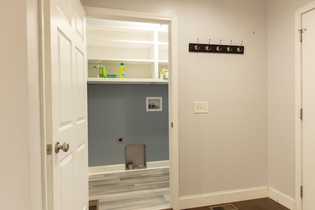 laundry room with hardwood / wood-style flooring, electric dryer hookup, and washer hookup