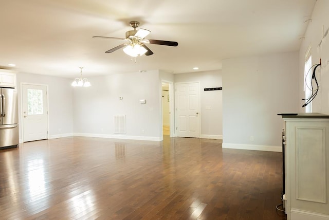 unfurnished living room with dark hardwood / wood-style floors and ceiling fan with notable chandelier