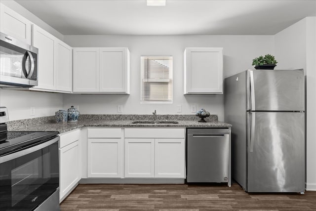 132 Village Creek Dr, Chatsworth, GA 30705 - kitchen featuring stainless steel appliances, a sink, white cabinets, light stone countertops, and dark wood finished floors