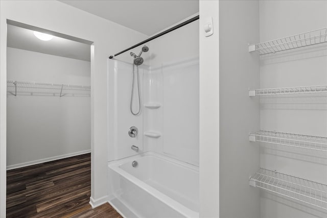 132 Village Creek Dr, Chatsworth, GA 30705 - bathroom with shower / bathtub combination, wood finished floors, a walk in closet, and baseboards