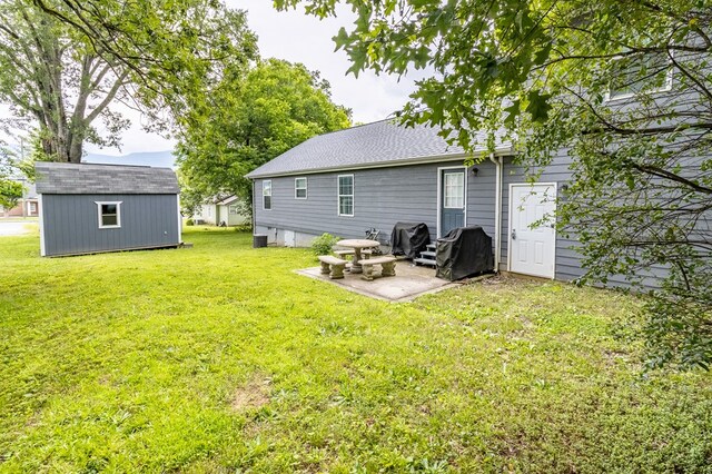 207 Pine St, Chatsworth, GA 30705 - rear view of house featuring a patio, a yard, an outbuilding, and roof with shingles
