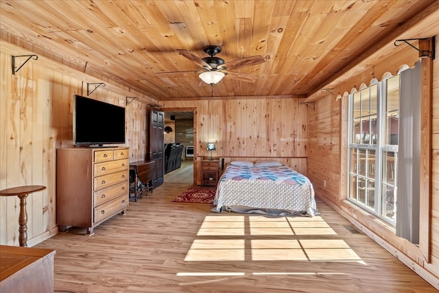 bedroom with hardwood / wood-style flooring, wooden ceiling, multiple windows, and wood walls