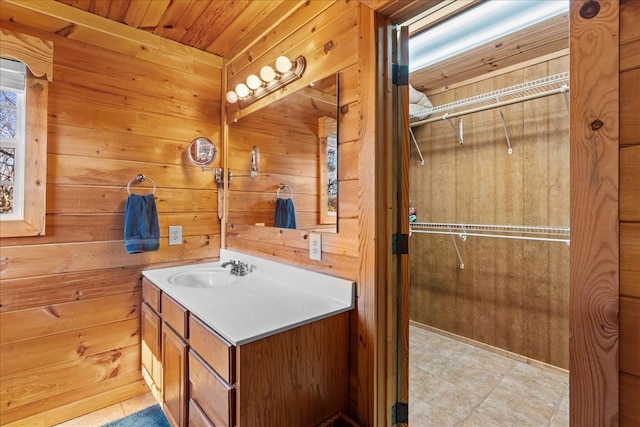 bathroom with vanity, wood ceiling, and wooden walls