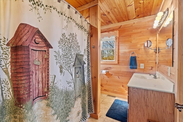 bathroom with tile patterned floors, wood walls, wooden ceiling, vanity, and a shower with shower curtain