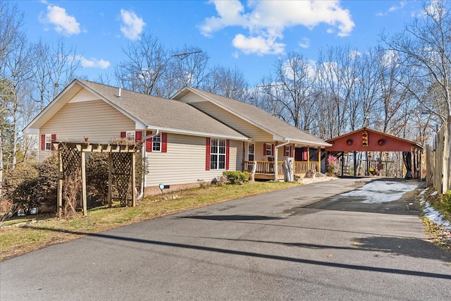 ranch-style home featuring a porch and a carport