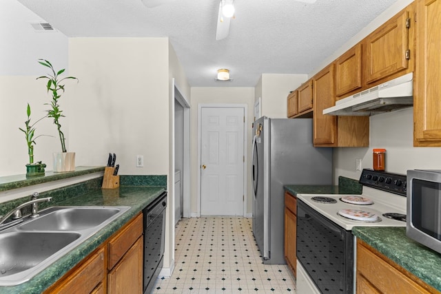 163 Shawn Ln, Chatsworth, GA 30705 - kitchen featuring appliances with stainless steel finishes, under cabinet range hood, light flooring, brown cabinets, and dark countertops