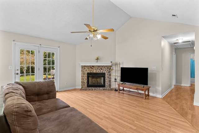 163 Shawn Ln, Chatsworth, GA 30705 - living area with light wood-style floors, a ceiling fan, vaulted ceiling, a fireplace, and attic access