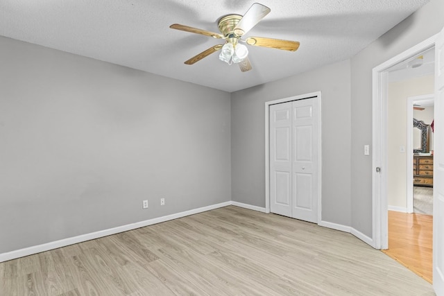 163 Shawn Ln, Chatsworth, GA 30705 - unfurnished bedroom with light wood finished floors, a closet, a ceiling fan, and a textured ceiling
