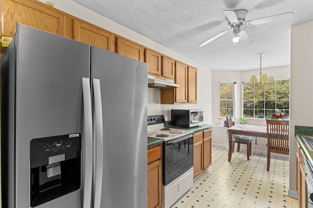 163 Shawn Ln, Chatsworth, GA 30705 - kitchen featuring appliances with stainless steel finishes, under cabinet range hood, a ceiling fan, brown cabinets, and light floors