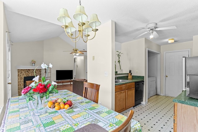 163 Shawn Ln, Chatsworth, GA 30705 - dining room with ceiling fan, light flooring, a chandelier, a stone fireplace, and vaulted ceiling