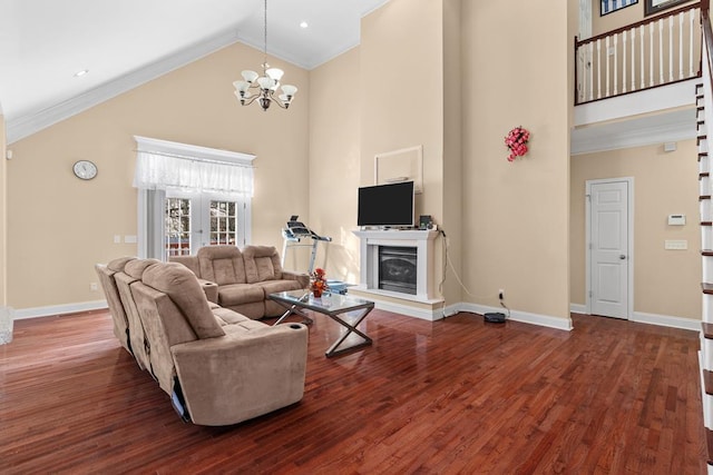 living room featuring ornamental molding, dark hardwood / wood-style flooring, a chandelier, and high vaulted ceiling