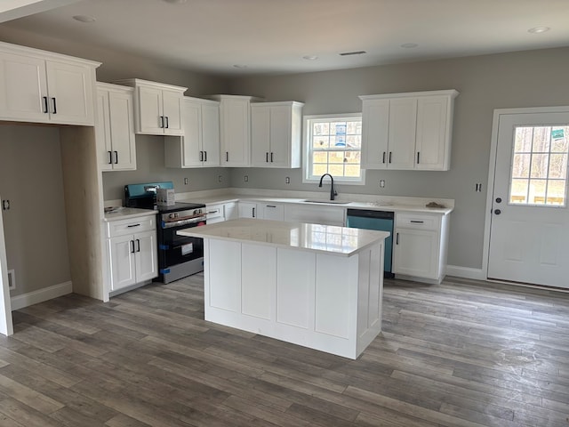 kitchen with a wealth of natural light, electric range, dishwashing machine, and a sink