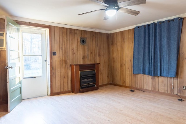 living room with ceiling fan, ornamental molding, hardwood / wood-style floors, and wood walls