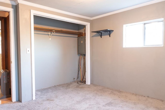 unfurnished bedroom featuring crown molding, light colored carpet, electric panel, and a closet