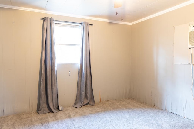 carpeted spare room featuring crown molding