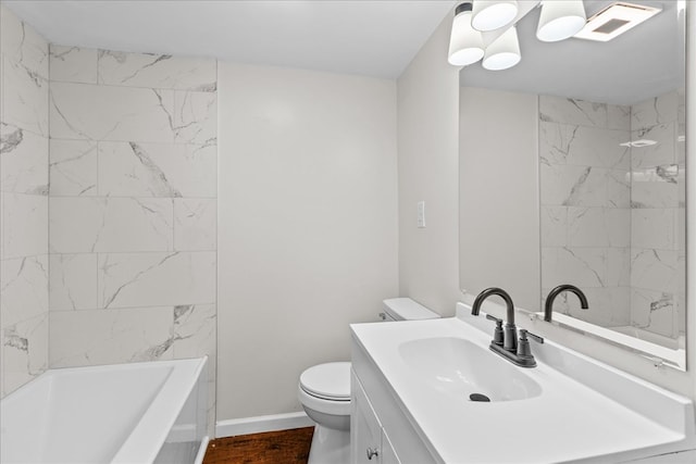 full bath with baseboards, vanity, and toilet