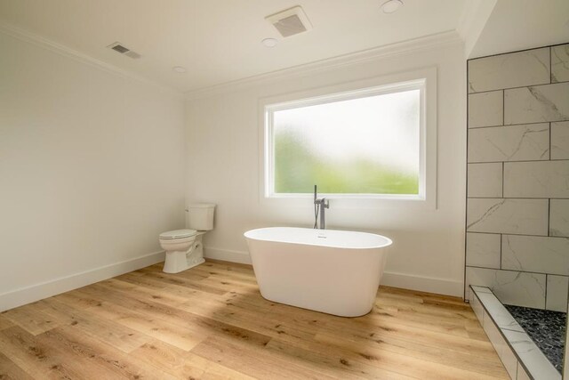 209 Crest Dr, Rocky Face, GA 30740 - full bath featuring crown molding, a freestanding bath, wood finished floors, baseboards, and toilet