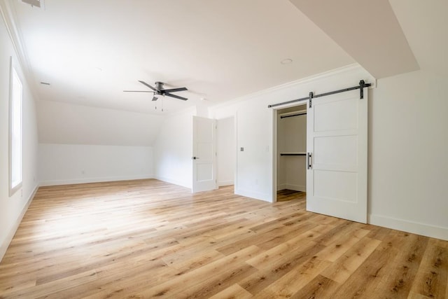 209 Crest Dr, Rocky Face, GA 30740 - additional living space with a barn door, a ceiling fan, light wood-style floors, baseboards, and lofted ceiling