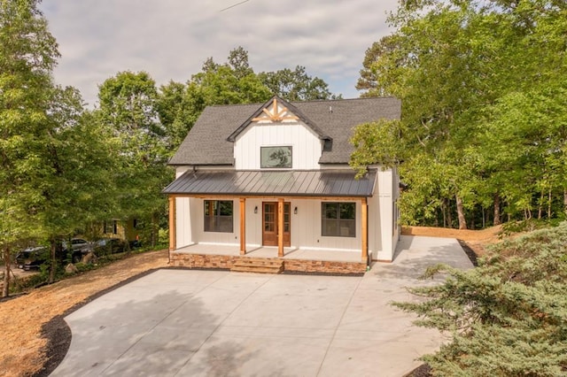 209 Crest Dr, Rocky Face, GA 30740 - view of front of property featuring a standing seam roof, covered porch, board and batten siding, metal roof, and roof with shingles