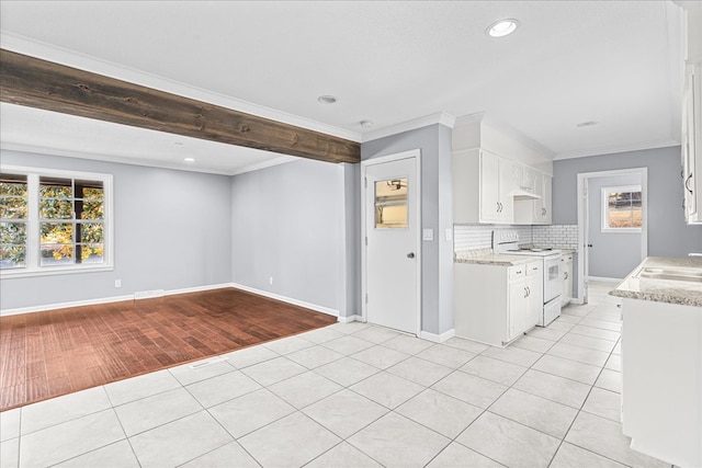 kitchen with white electric range, ornamental molding, white cabinets, and light tile patterned flooring