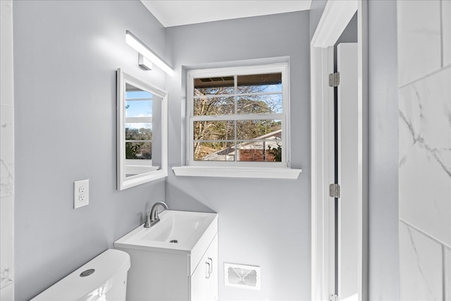 bathroom with vanity and toilet