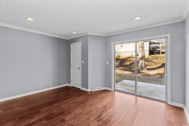 empty room featuring hardwood / wood-style flooring, ornamental molding, and a textured ceiling