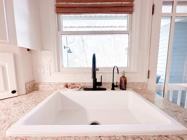 interior details with light countertops and a sink