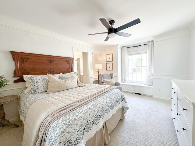 bedroom with light carpet, ornamental molding, and a ceiling fan